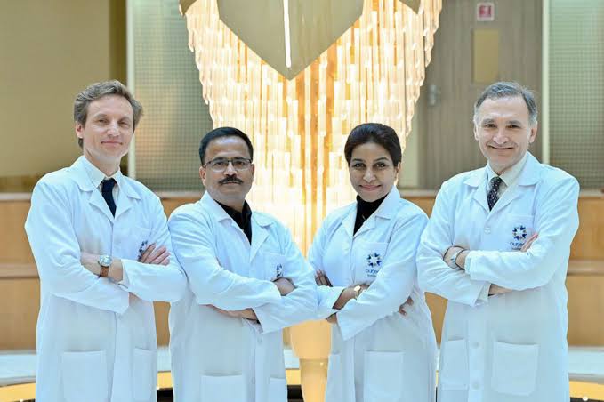 Dr. Sandesh Kade with his gynecology team in white coats
